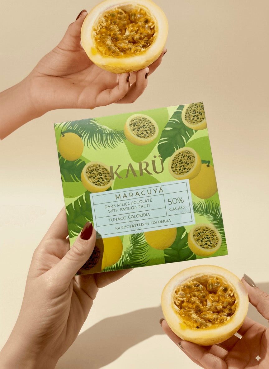 Person holding a passion fruit and a Karu chocolate bar.